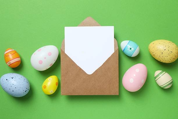 istock Happy Easter. Colorful eggs with paper envelope on green background, space for text or advertising 2253733198