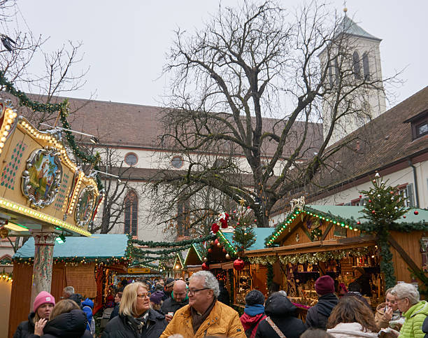 Freiburg, Germany - December 22, 2025:The famous city during the Christmas season. Festive atmosphere with historic architecture and everyday city life visible. A traditional Christmas market with decorated stalls is visible.