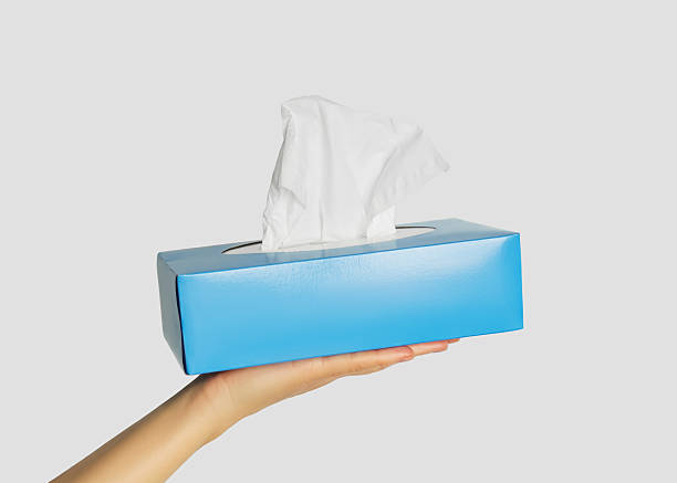 istock Hand holding a blue box of facial tissues 2253733435