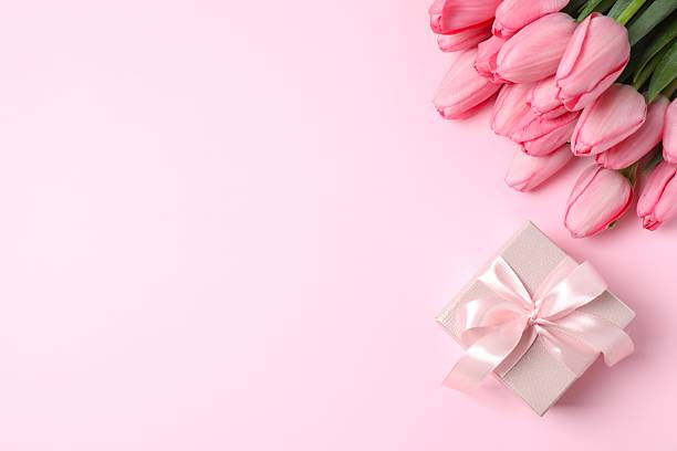 istock Beautiful fresh tulips with gift box on color background 2253734926