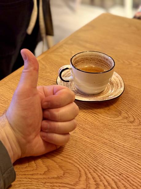 istock Gesture Praising Daily Beverage, Friendly Gesture Showing Satisfaction With Morning Espresso And Ambiance, Warm Gesture Of Approval Towards Cozy Morning Coffee Scene In Welcoming Cafe 2253735377