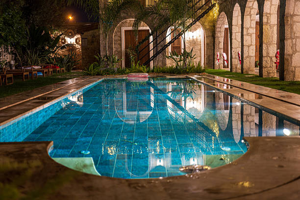 Young blonde woman relaxing in swimming pool at spa resort