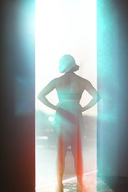 Rear portrait of a fit woman exudes confidence and strength as she strikes a powerful pose, her athletic physique showcased in sleek workout gear.