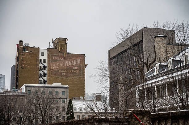 Old Insurance Company advertisement paintyed on building downtown Montreal during winter day