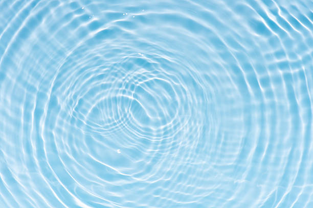 istock Bluewater waves on the surface ripples blurred. Defocus blurred transparent blue colored clear calm water surface texture with splash and bubbles. Water waves with shining pattern texture background. 2253737799