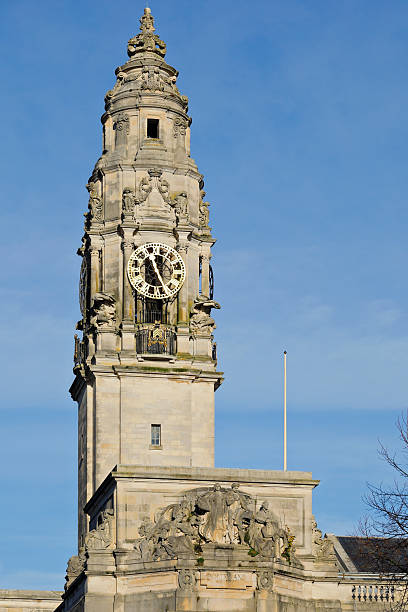 The clock tower of Cardiff City Hall rises above the civic centre in Cardiff, Wales, UK. Completed in the early 20th century, the building is a prominent example of Edwardian Baroque civic architecture and serves as a landmark of the Welsh capital.