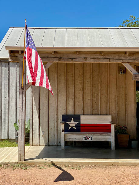 istock American Flag and Texas Flag Bench Under a Porch 2253742100