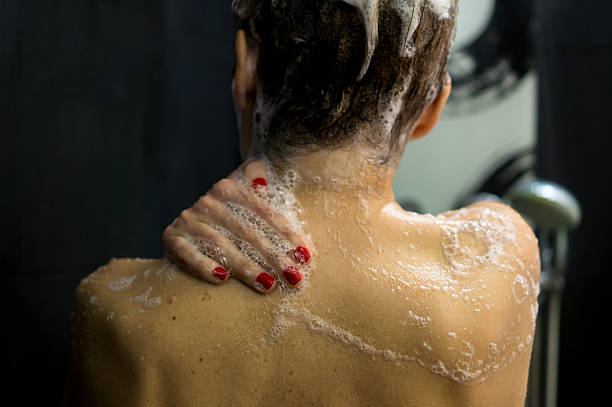 istock Refreshing Shower: Person Washing Shoulder with Soap Bubbles 2253742669