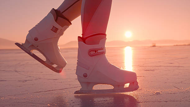 Gild with white skates on ice.