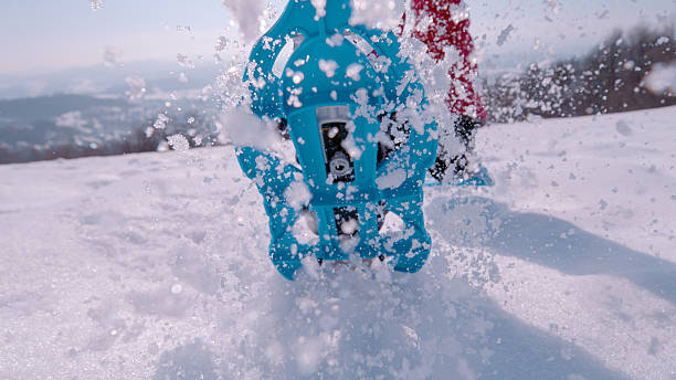 istock CLOSE UP, LOW ANGLE VIEW: Snowshoeing through fresh snow on a sunny winter day 2253743561