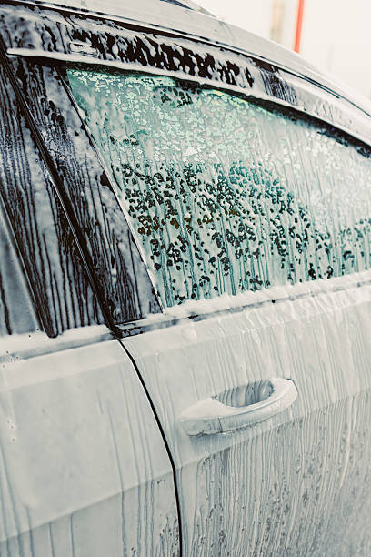 istock This visual illustrates the Car Wash Process, showcasing a soapy vehicle with glistening water droplets, emphasizing the detailed work needed for a perfect shine and sparkle for any car 2253743709
