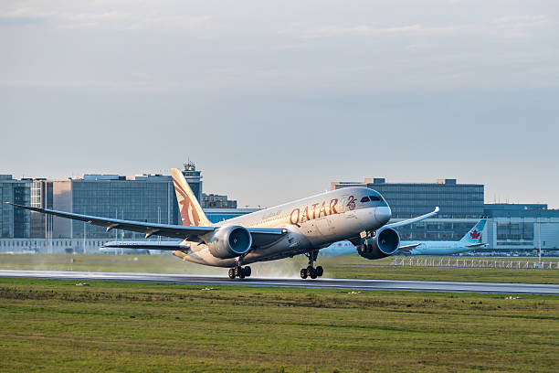 Brussels, Belgium - Dec 21, 2025: Qatar Airways Boeing 787 Dreamliner lifting off from the runway at Brussels Airport with terminal buildings in background.