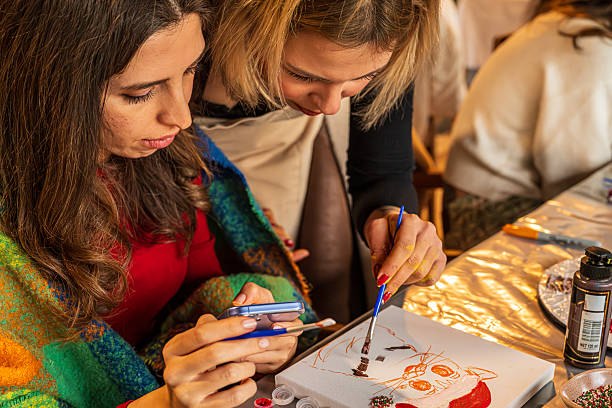 istock Two Women Collaborating on a Holiday Art Workshop Painting 2253745351