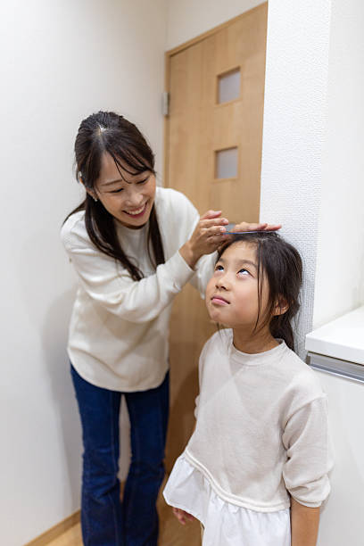 istock Mother measuring her daughter’s height at home 2253748061