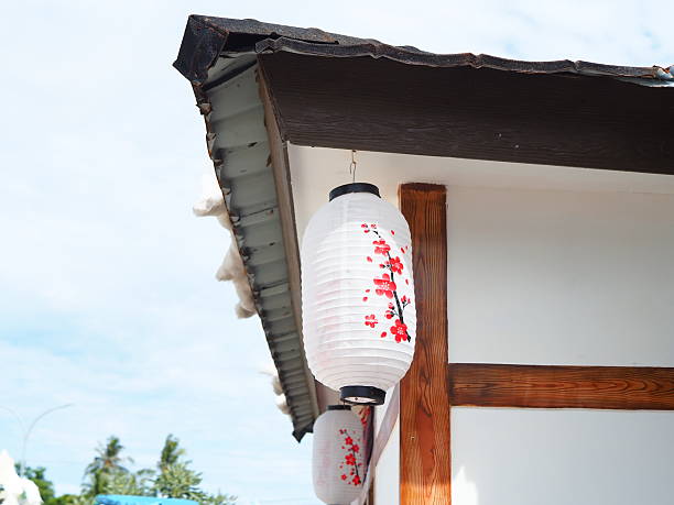 istock Japanese lantern with cherry blossoms hanging under traditional roof 2253749333