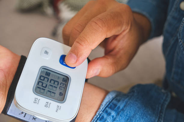 istock Person checking blood pressure using a wrist monitor 2253749455