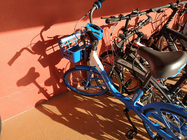 Singapore, Nov 23, 2025: Urban bicycle photographed against a wall with strong light and shadow, suitable for transport, lifestyle, and sustainability concepts