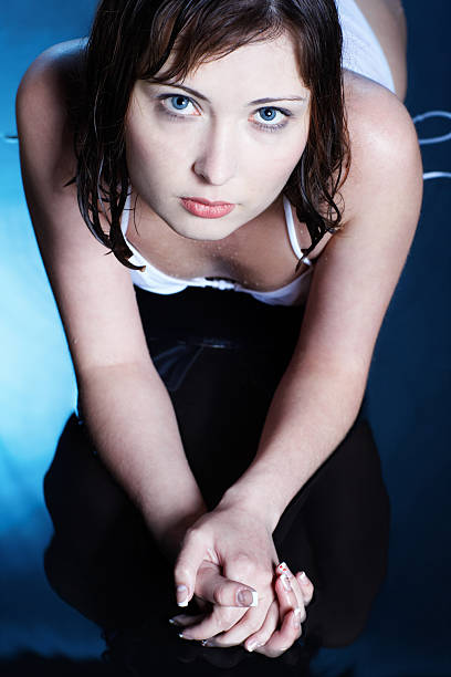 portrait of brunette female laying on blue water floor