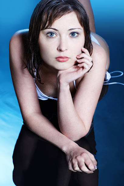Beauty soft portrait of a Caucasian woman looking at you through the window.