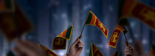 Sri Lanka flags in their hands on a blurred urban background. The photo illustration was created without the use of artificial intelligence, only using Photoshop.