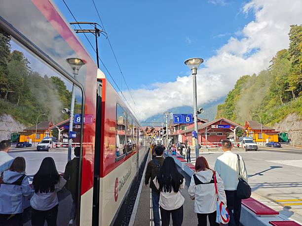 Brienz,Switzerland-Oct.1st 2025: Train at Brienz railway station with passengers walking on the platform