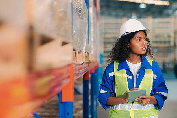 istock Female logistics worker using digital tablet for smart inventory management in automated warehouse. 2253760867