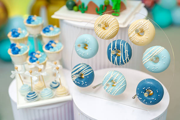 Blue and White Mini Donuts Displayed on Dessert Stand for Event Celebration