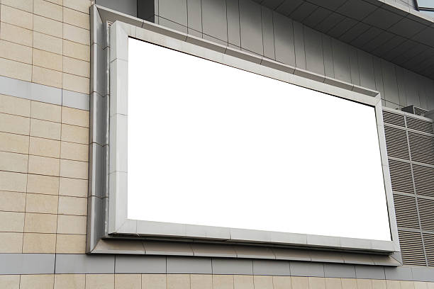 istock A mockup of a blank white billboard framed by a modern building facade, ideal for advertising 2253763514
