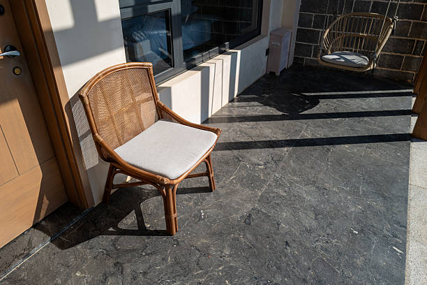 The light and shadows on the balcony's lounge chair