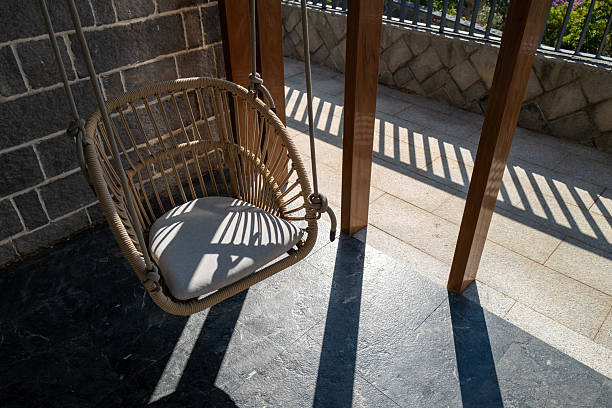 The light and shadows on the balcony's lounge chair