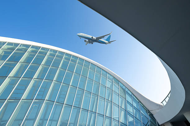 istock Looking up at modern architectural shapes to see airplanes 2253765848