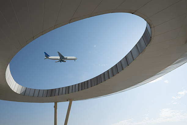 istock Looking up at modern architectural shapes to see airplanes 2253765854
