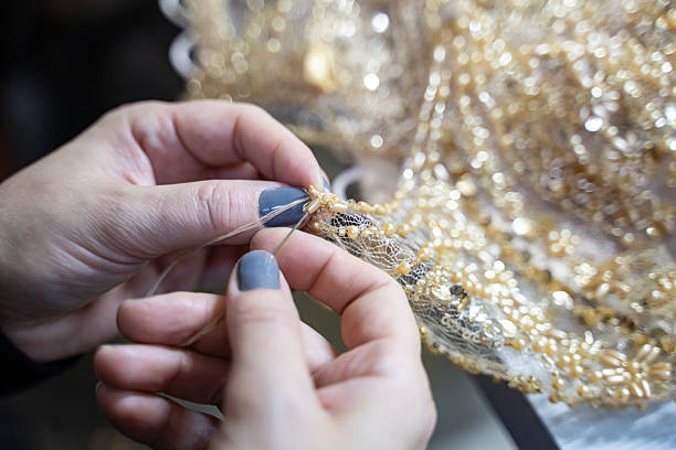 istock A designer is sewing a yellow evening gown. (stock photo) 2253765994