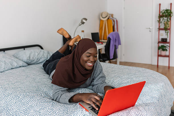 istock Happy young female student working on laptop at home. 2253766524