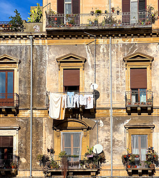 istock Weathered apartment building facade with laundry drying on balcony in italy 2253769457