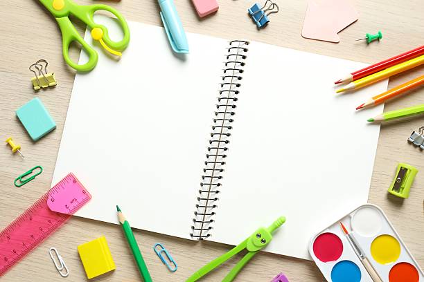 istock Flat lay with school stationery with open notebook on wooden background, top view 2253769712