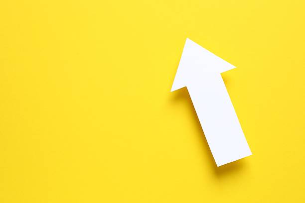 istock Paper arrow on color background, top view 2253771033