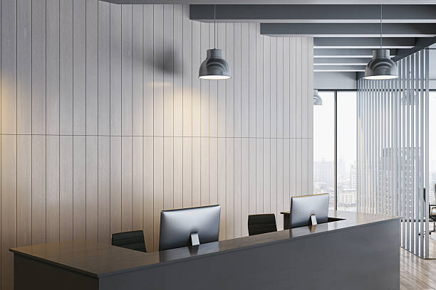 istock Modern empty corporate reception area with sleek desk, computers, and wood panel wall in bright workspace interior for branding mockup template. 3D Rendering 2253771055