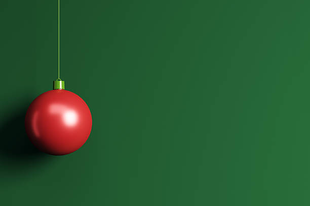 Red Christmas ornament hanging on string, minimal modern style on green background, blank wall copyspace for banner, logo, or postcard design. 3D Rendering.