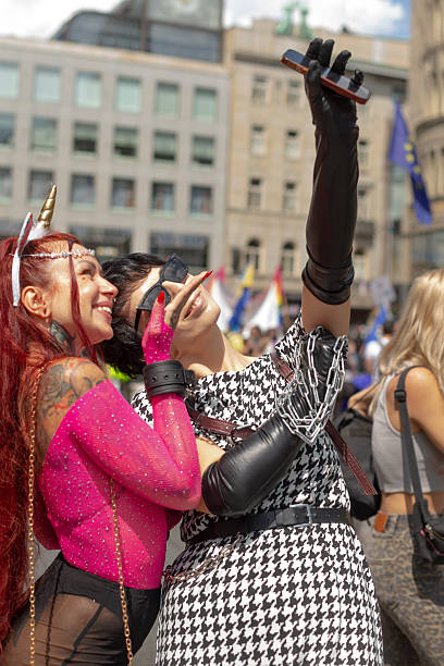 istock two individuals pose amidst pride celebration, couple embraces closely during vibrant pride rally event 2253772680