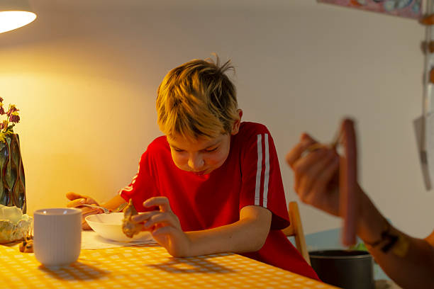 istock Child dressed brightly scrutinizes detailed small sculpture attentively 2253773156