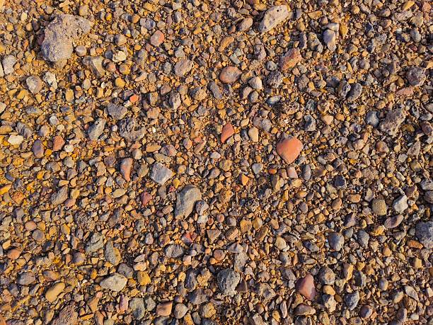 The image of a close-up texture of mixed gravel and dirt.