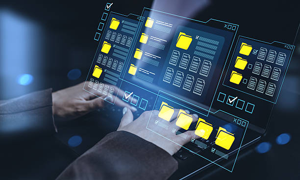 istock Hands interacting with futuristic digital interface showing file folders and documents on a transparent screen over laptop keyboard in modern concept setting. 2253775935