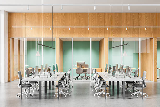 istock Modern open space office interior with shared desks and glass meeting rooms in minimalist wooden and mint green design. 3D Rendering. 3D Rendering 2253776506