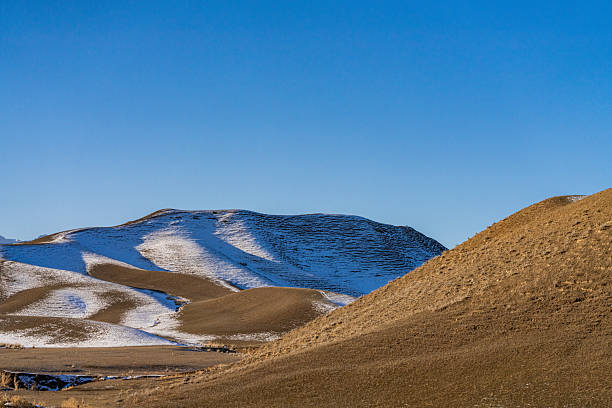 Dry grasslands and white snow on a sunny winter day