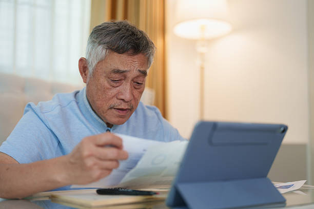 istock Older Asian man suffering from a headache during his work at home 2253779998