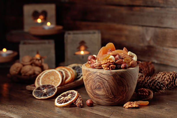 istock Dried fruits and assorted nuts on a wooden table. 2253780632