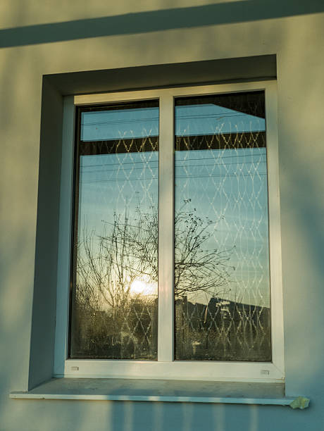 istock A window with a view of the sun setting through it 2253781006