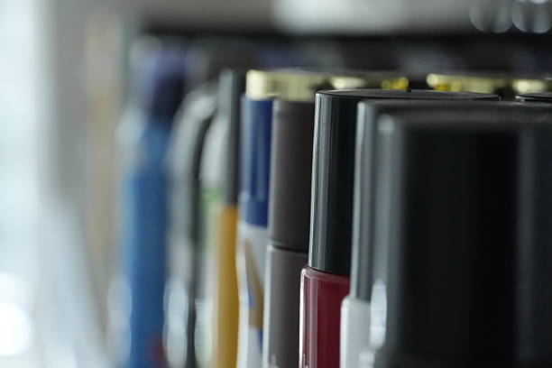 istock Several dark-colored bottles with various caps are neatly arranged on a store shelf. 2253783664