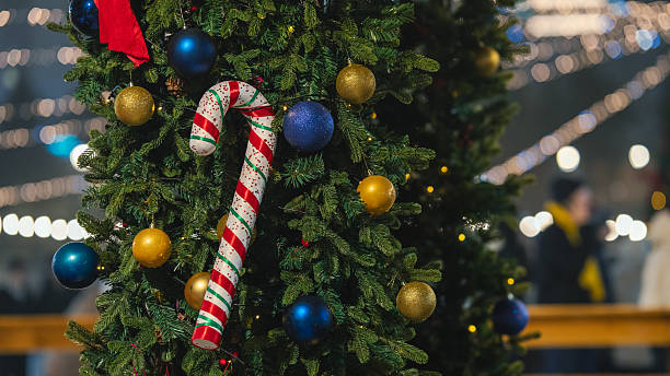 istock Christmas candy cane ornament on decorated Christmas tree 2253784751